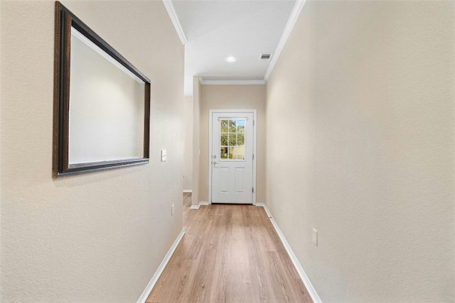 hall featuring light hardwood / wood-style floors and ornamental molding