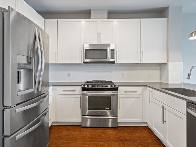 kitchen featuring stainless steel appliances, sink, and white cabinetry