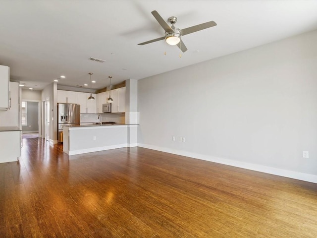 unfurnished living room with visible vents, baseboards, recessed lighting, dark wood-type flooring, and a ceiling fan