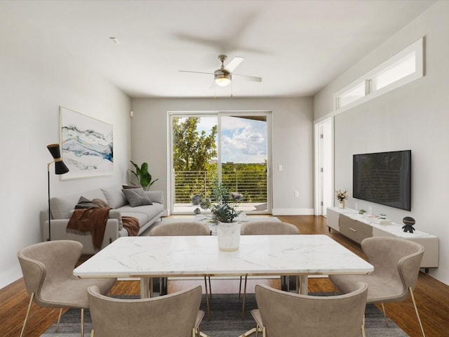 dining area with dark wood-type flooring, baseboards, and ceiling fan