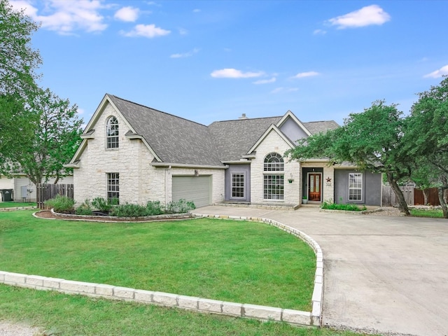 view of front facade with a garage and a front yard