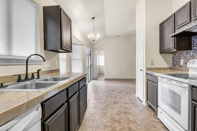 kitchen with pendant lighting, white appliances, an inviting chandelier, sink, and vaulted ceiling