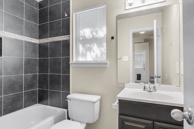 full bathroom featuring vanity, toilet, and tiled shower / bath