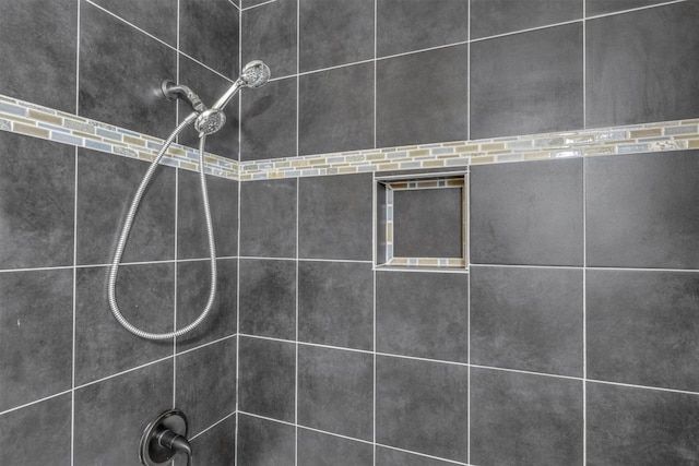 interior details with a tile shower