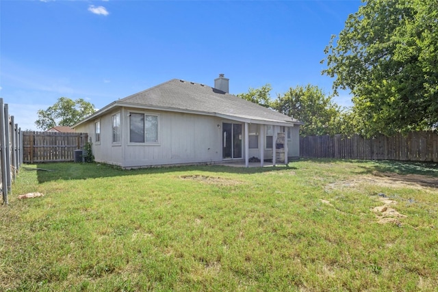 rear view of house featuring central AC, a yard, and a patio area