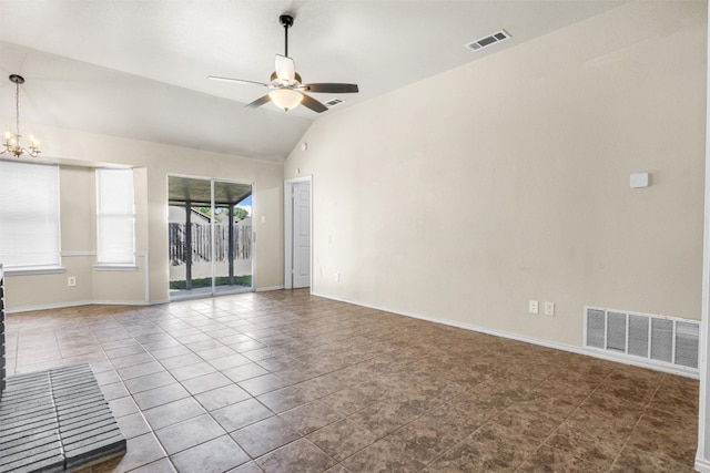 tiled spare room featuring lofted ceiling and ceiling fan with notable chandelier