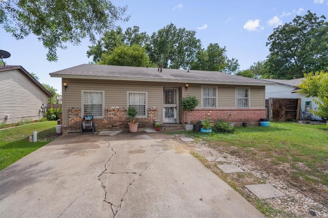 single story home with brick siding and a front lawn