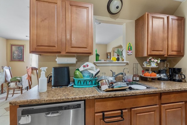 kitchen with a sink, tile patterned floors, light countertops, brown cabinets, and dishwasher