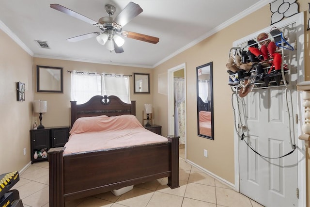 bedroom featuring light tile patterned floors, baseboards, visible vents, and crown molding