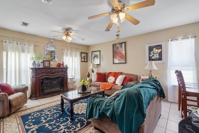 tiled living room with a healthy amount of sunlight and ceiling fan