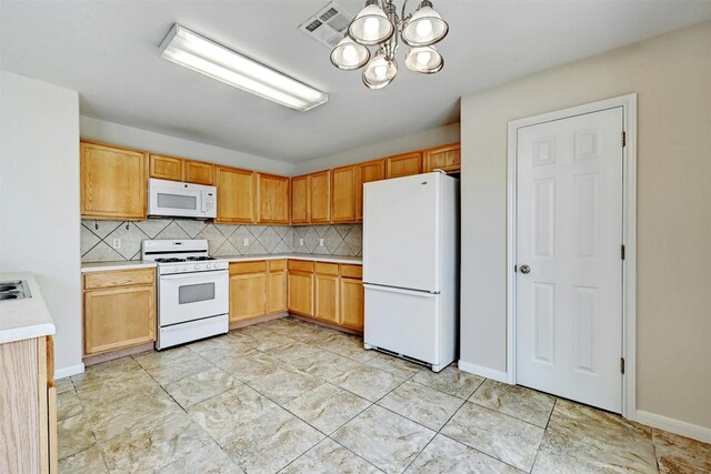 kitchen featuring decorative backsplash, white appliances, and a notable chandelier