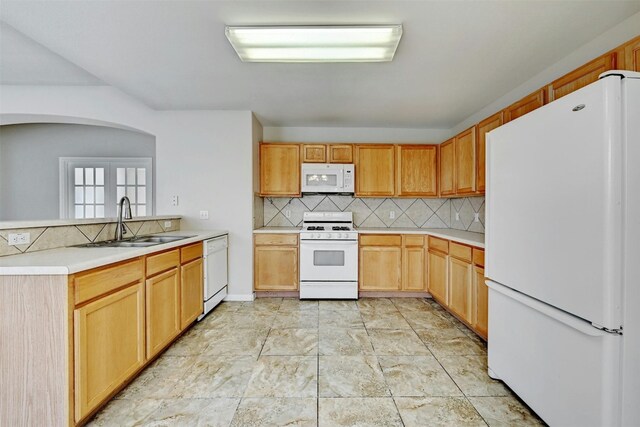 kitchen featuring decorative backsplash, french doors, kitchen peninsula, white appliances, and sink