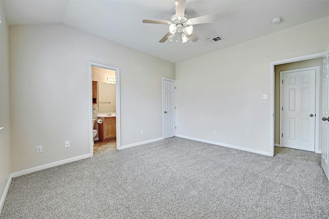 unfurnished bedroom with ceiling fan, a closet, carpet floors, and ensuite bath