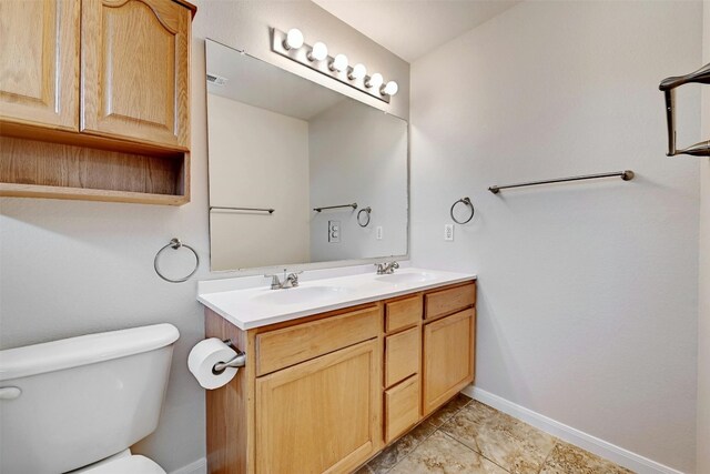 bathroom featuring tile patterned floors, vanity, and toilet