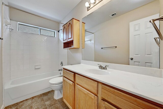 full bathroom with vanity, toilet, and tiled shower / bath