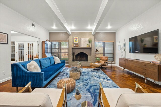 living room featuring dark wood-type flooring, ornamental molding, a brick fireplace, french doors, and beamed ceiling