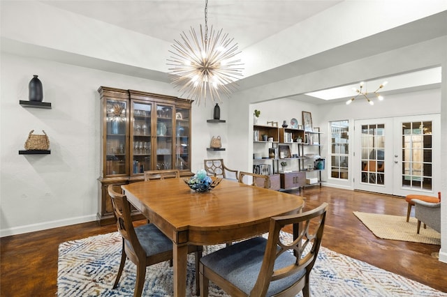 dining space with a chandelier and french doors