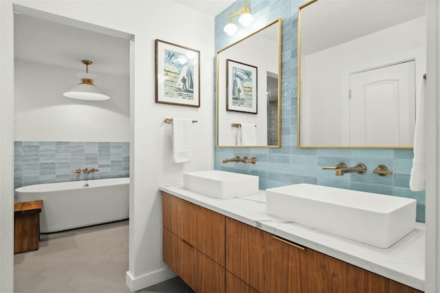 bathroom featuring vanity, tile walls, and a tub