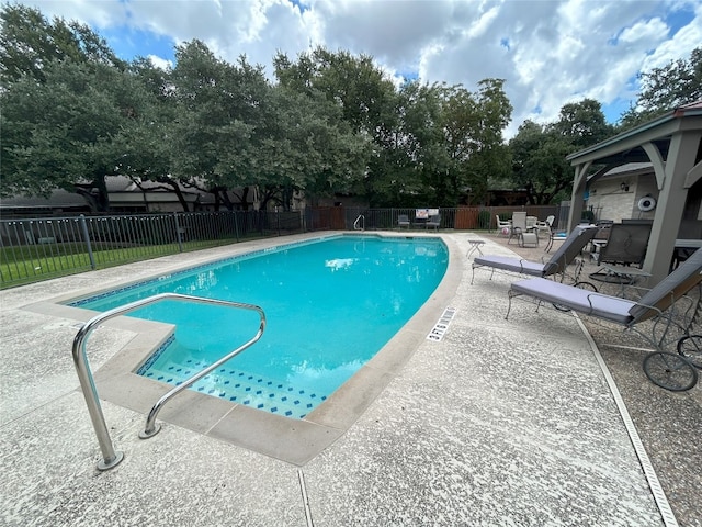 view of swimming pool featuring a patio area