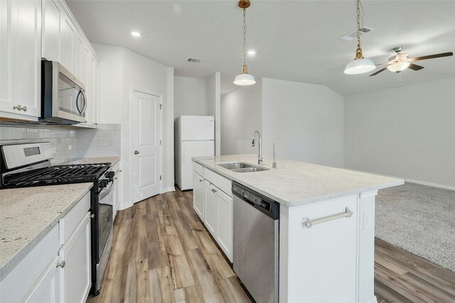 kitchen with visible vents, appliances with stainless steel finishes, decorative backsplash, and a sink