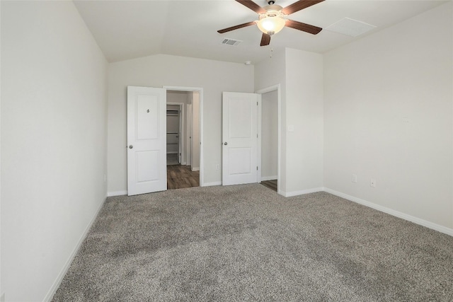 unfurnished bedroom with visible vents, lofted ceiling, a ceiling fan, carpet floors, and baseboards