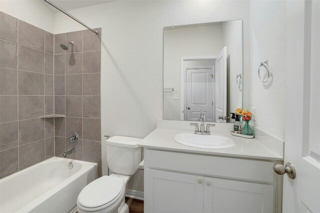 bathroom featuring toilet, vanity, and shower / bathing tub combination