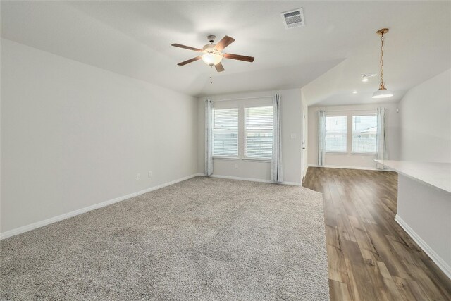 spare room featuring dark hardwood / wood-style flooring, ceiling fan, and vaulted ceiling