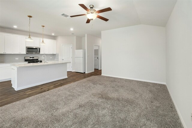 kitchen featuring a center island with sink, visible vents, a sink, stainless steel appliances, and white cabinets