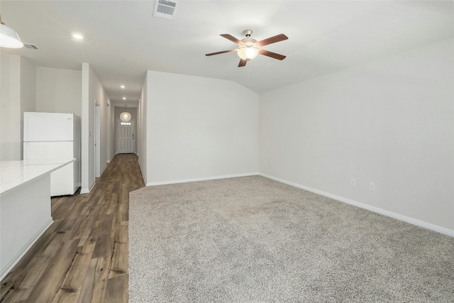 unfurnished room featuring lofted ceiling, baseboards, visible vents, and ceiling fan