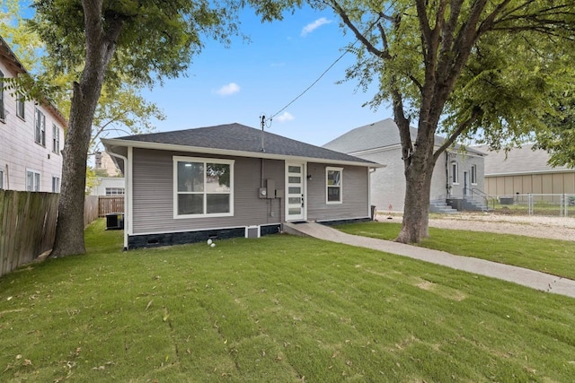 view of front of property with a front yard and cooling unit