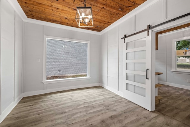 interior space featuring wooden ceiling, wood-type flooring, built in features, a chandelier, and a barn door