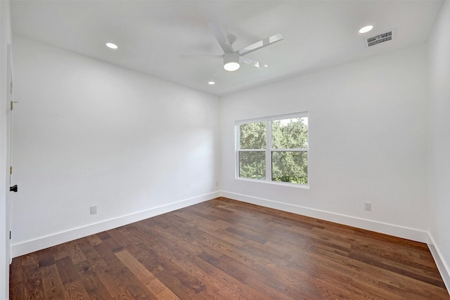 spare room featuring dark wood finished floors, recessed lighting, ceiling fan, baseboards, and visible vents