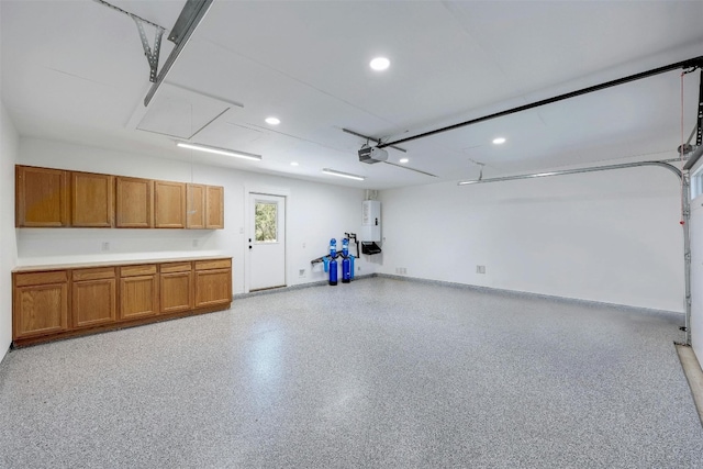 garage featuring a garage door opener and water heater