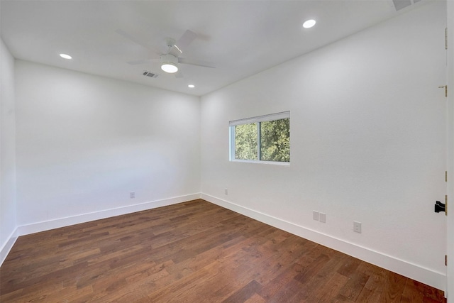 unfurnished room with baseboards, visible vents, ceiling fan, and dark wood-type flooring