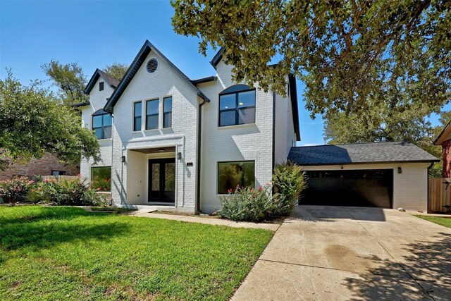 view of front of house featuring a front yard and a garage