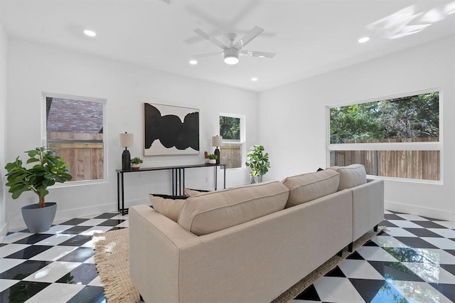 living room featuring ceiling fan and a healthy amount of sunlight