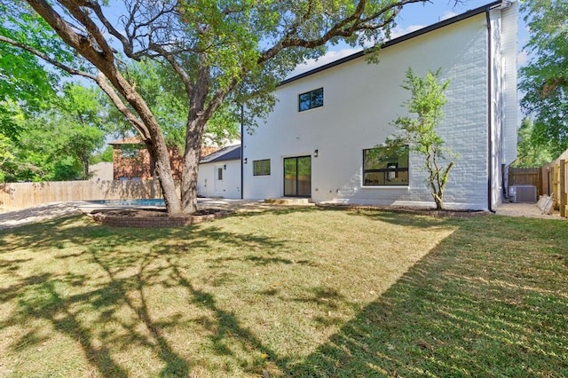 back of property featuring a patio, cooling unit, and a yard