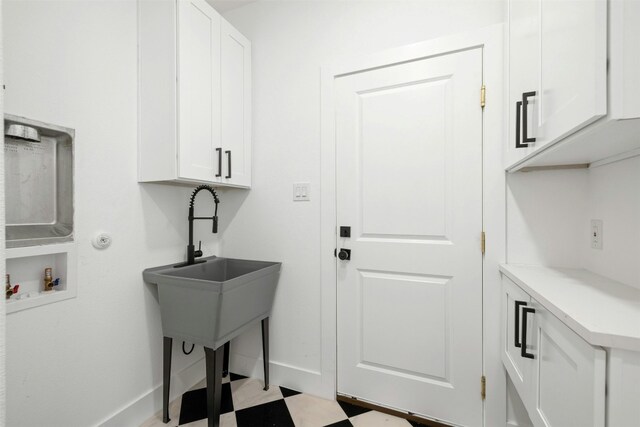 laundry room with cabinets and washer hookup