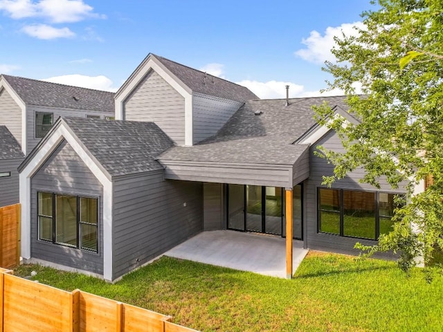 back of house with a lawn and a patio