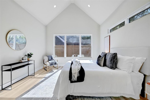 bedroom with light hardwood / wood-style flooring and vaulted ceiling