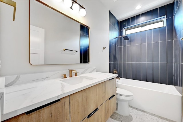 full bathroom featuring toilet, vanity, and tiled shower / bath combo