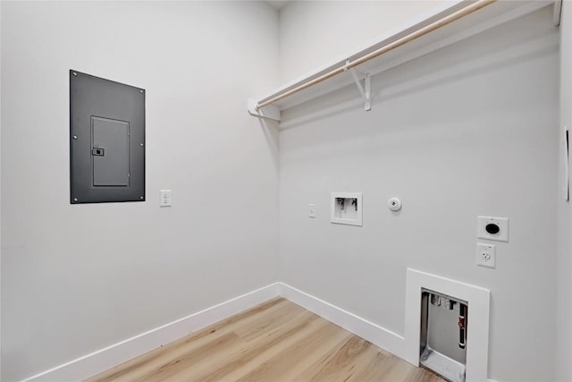 clothes washing area with washer hookup, electric dryer hookup, hookup for a gas dryer, electric panel, and hardwood / wood-style floors