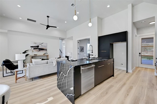 kitchen with ceiling fan, sink, light hardwood / wood-style flooring, stainless steel dishwasher, and decorative light fixtures