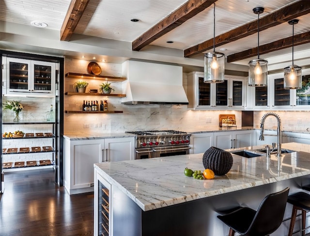 kitchen with range with two ovens, dark wood-type flooring, custom exhaust hood, and tasteful backsplash