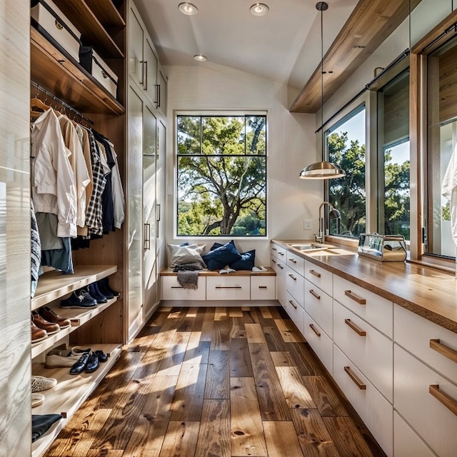 mudroom featuring lofted ceiling, sink, and dark hardwood / wood-style floors