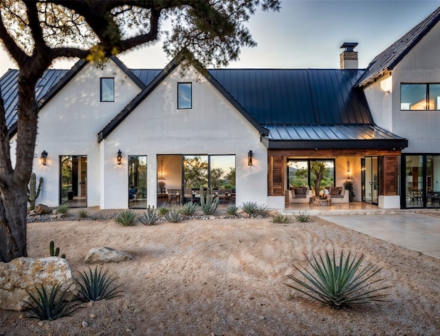 back of property featuring a patio