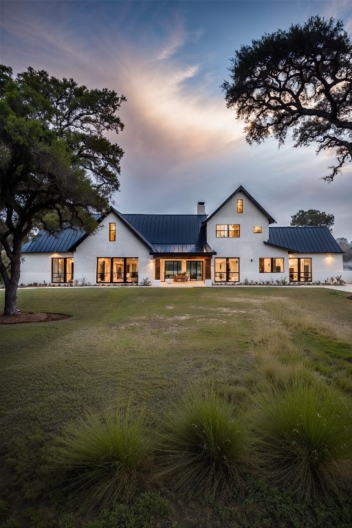 modern farmhouse with a yard