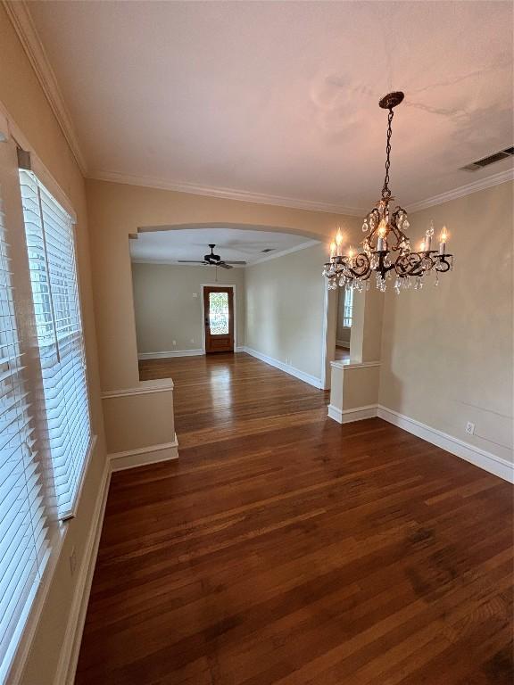 510 S Church St, Georgetown, TX 78626 - unfurnished dining area with ceiling fan, a chandelier, dark wood-type flooring, ornamental molding, and arched walkways