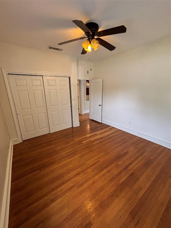 510 S Church St, Georgetown, TX 78626 - unfurnished bedroom with wood finished floors, a closet, and ceiling fan