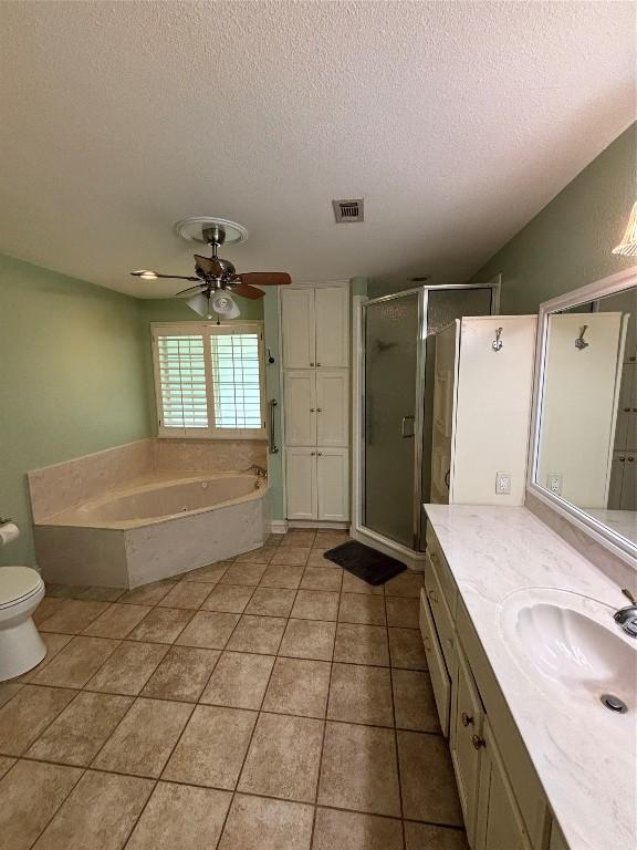 510 S Church St, Georgetown, TX 78626 - bathroom with a textured ceiling, a shower stall, vanity, a garden tub, and a ceiling fan